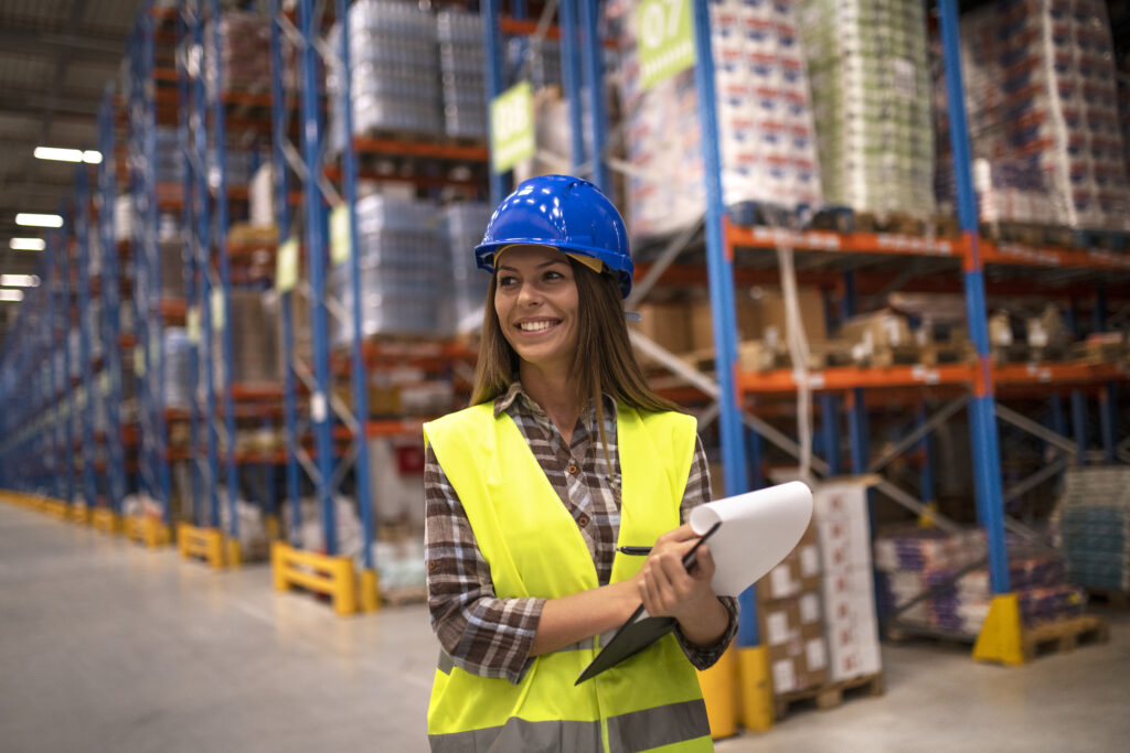 portrait of female worker in distribution warehouse looking aside.